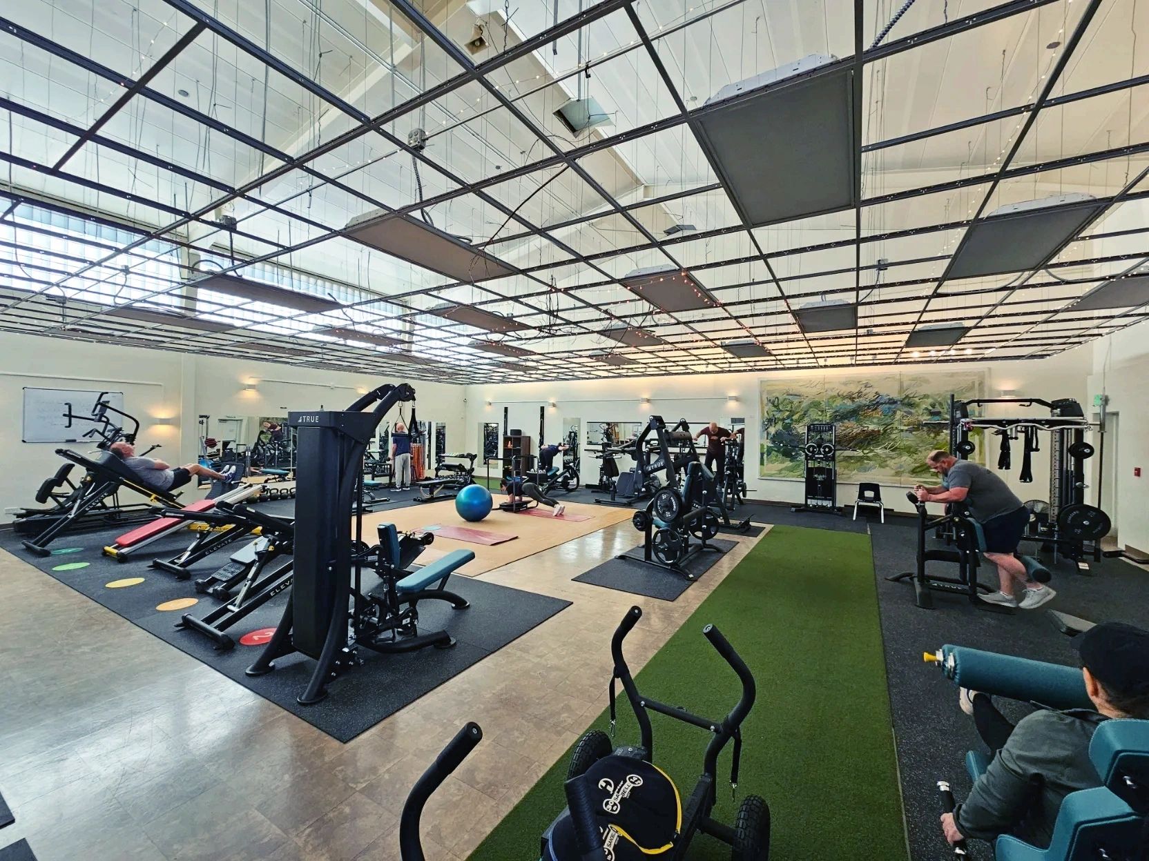 Wildfire fitness studio wide angle view of main studio area with machines and members.