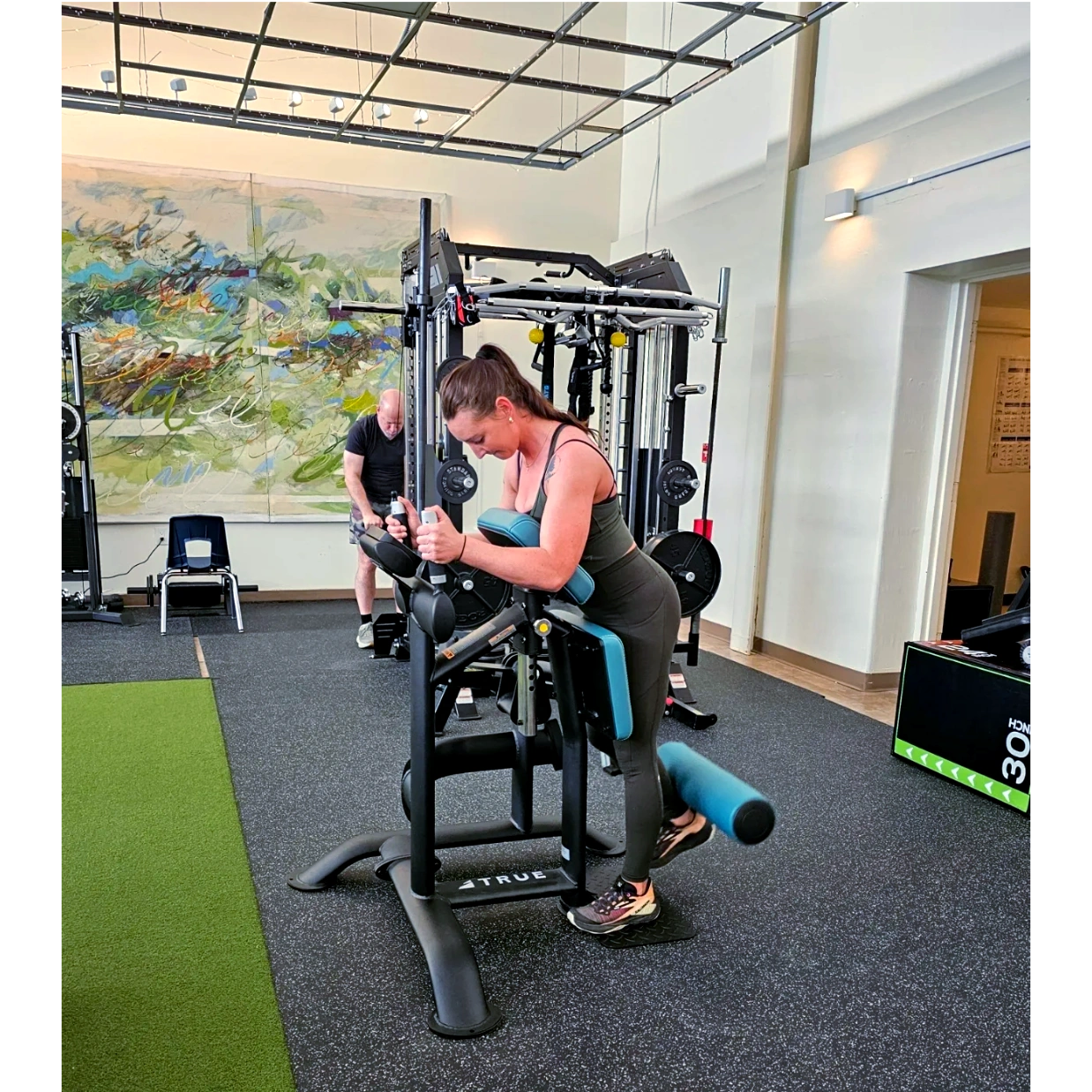 Client performing a standing leg curl.