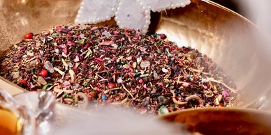 Decorative bowls with spices, cinnamon sticks, and pearl-embellished ornaments.