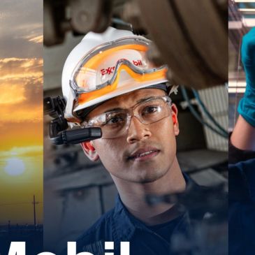 A technician wearing safety gear inspects machinery.