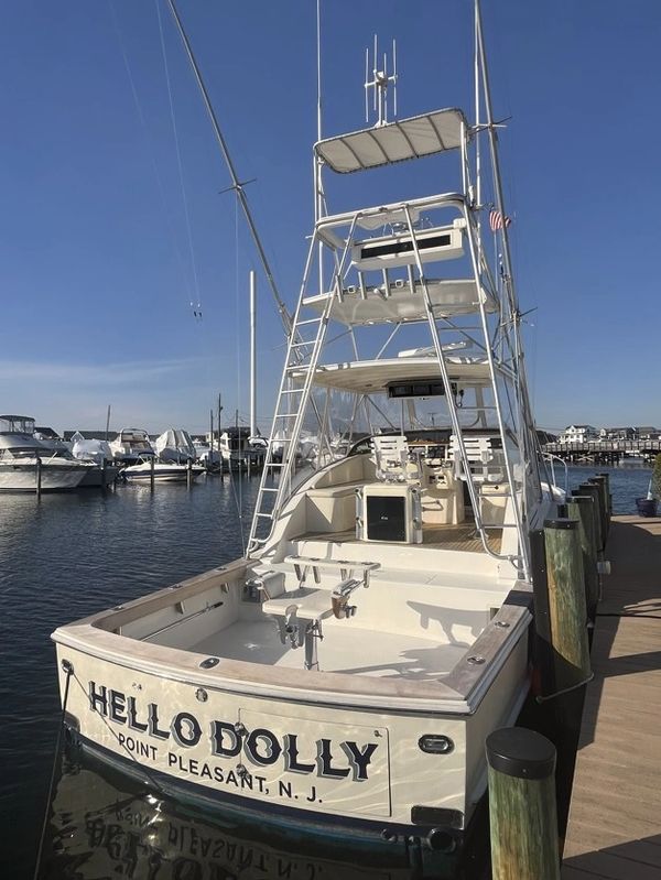 Fishing boat named 'Hello Dolly' docked at Point Pleasant, NJ marina.