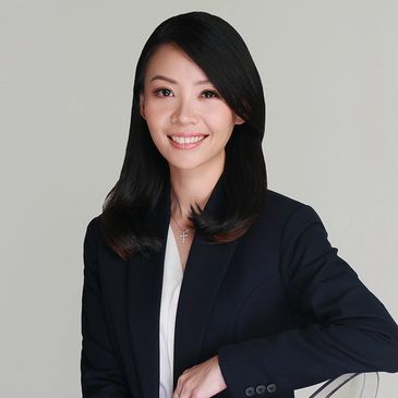 Smiling woman in business attire.