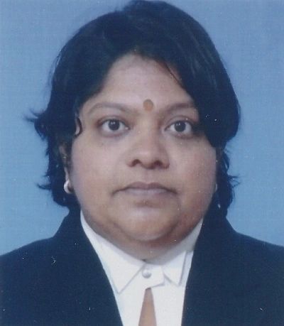 Professional headshot of a woman in formal attire with a bindi.
