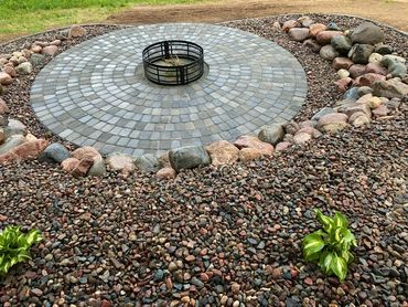 Circle paver patio with fire ring and boulder wall