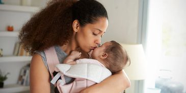 Mother kissing baby, nurturing mothers and babies