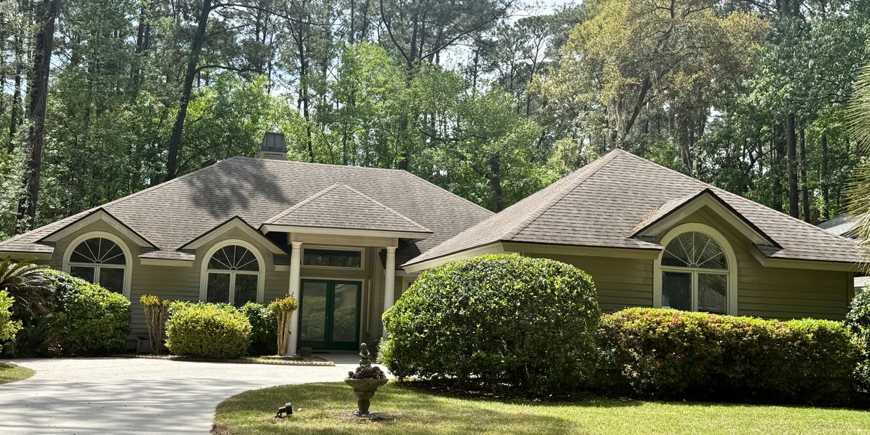 Well-maintained home in Spring Lake, Hilton Head Plantation with mature landscaping and wooded views