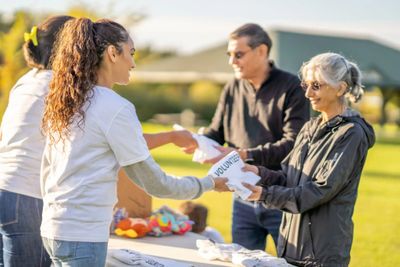 Volunteers assisting seniors at an event