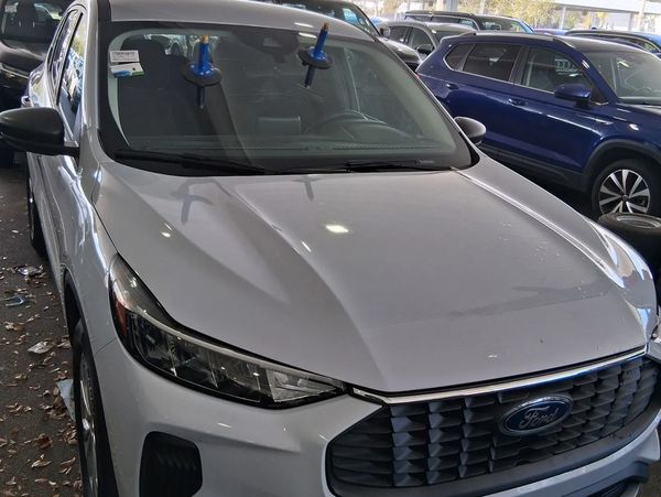 White Ford SUV with windshield suction cups parked indoors.