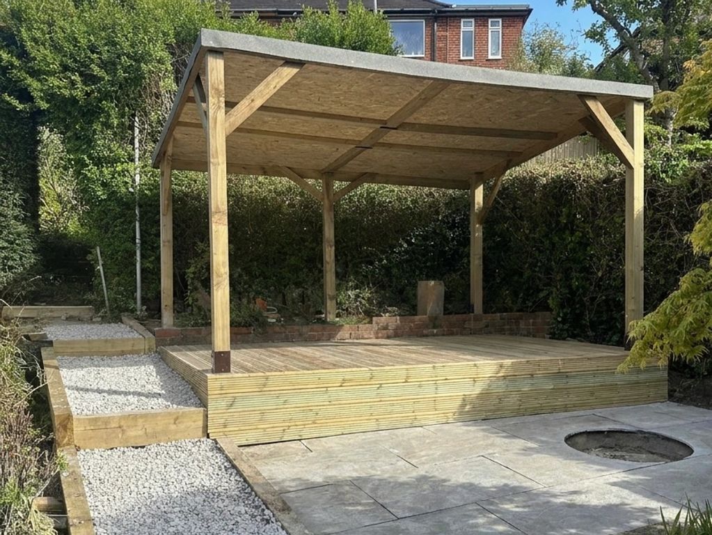 Wooden pergola with a raised deck and gravel path in a garden.