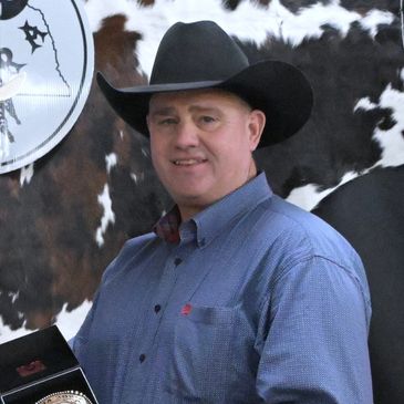 Man wearing a cowboy hat and blue shirt.