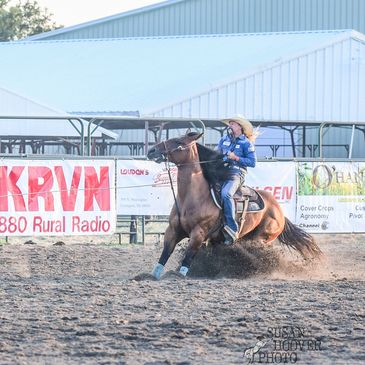 Cowboy performing a fast horseback turn in an arena.