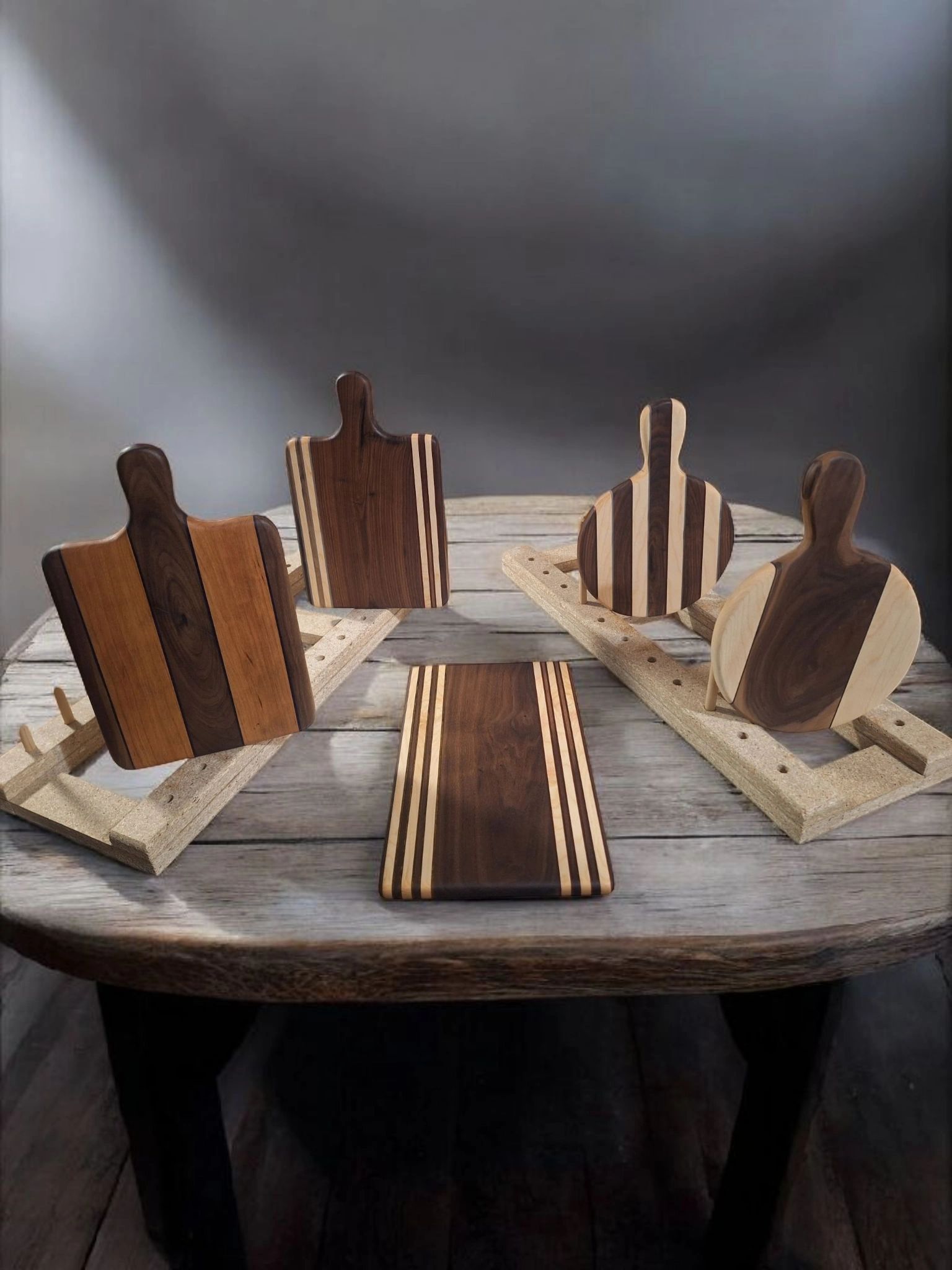 Striped wooden cutting boards displayed on a rustic table.