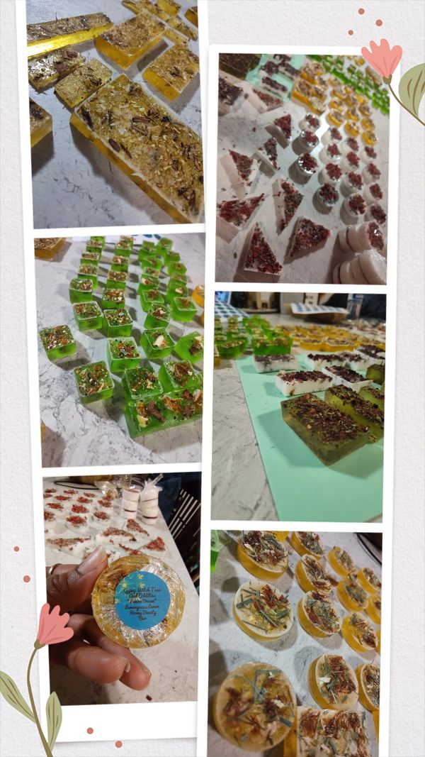 Assorted handmade herbal soaps with natural ingredients and decorative herbs.