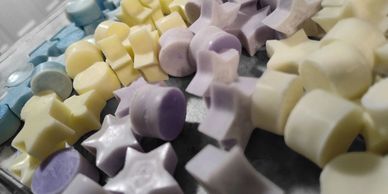 Colorful star and flower-shaped candies in pastel shades.