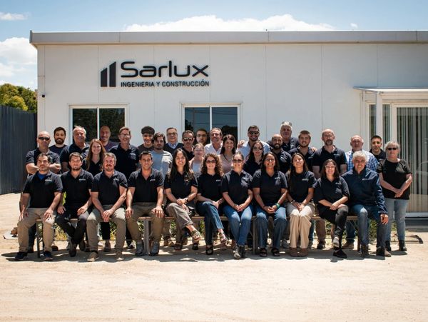 Group photo of Sarlux engineering and construction team outside their office.