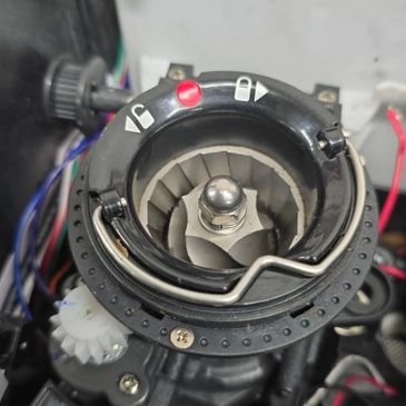 Close-up of a mechanical component with blades and adjustment knob.