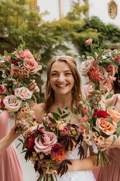 bride's face surrounded by bouquets of flowers in fall colors