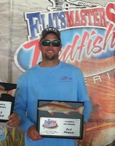 Captain John with a 1st place trophy in a professional redfish tournament