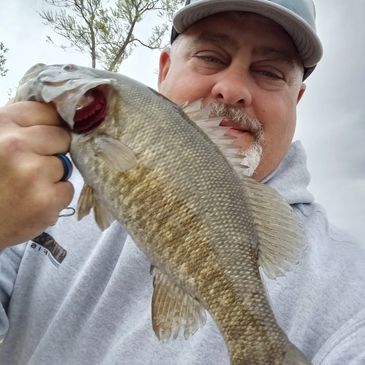 Angler holding a smallmouth caught