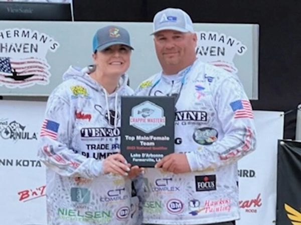 Bethany and Cameron White holding a trophy for top male/female team