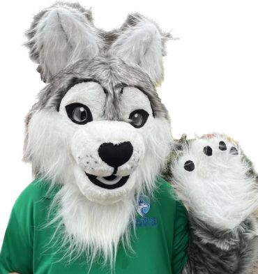Person in a smiling wolf mascot costume.