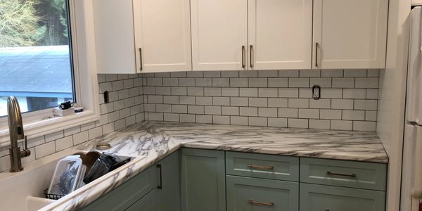 Kitchen with a finished tile backsplash.