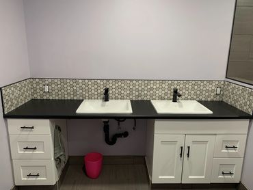 Bathroom vanity surrounded with a backsplash.
