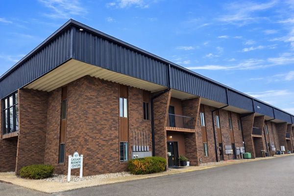 Brick and metal commercial building under a blue sky.