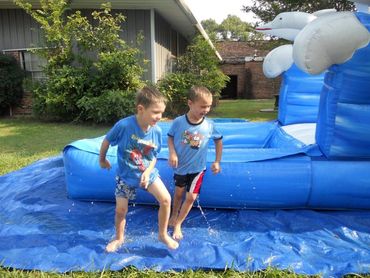 Brothers enjoying water slide