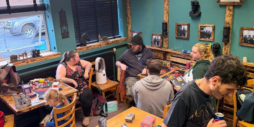 People gathered in a cozy room playing Lorcana