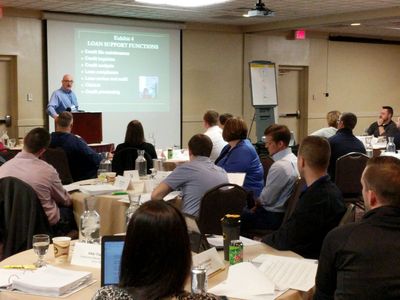 People attending a business presentation in a conference room.