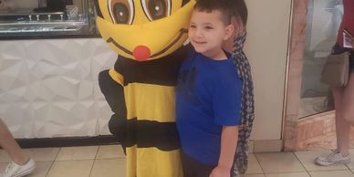 Blues the Bee with a little boy at the mall.