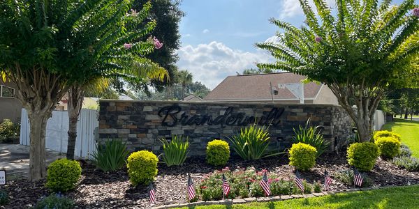 a neighborhood entrance with fresh landscaping and plants