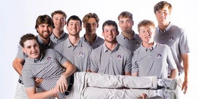 A group of nine young men in matching striped shirts, one held horizontally.
