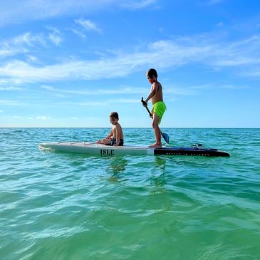 Just a couple of dudes and their board catching some rays.