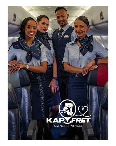 Four flight attendants posing inside an airplane cabin.