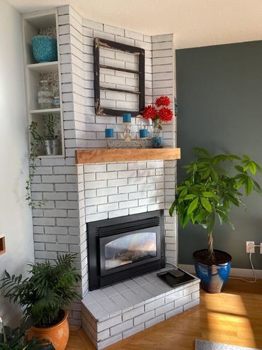 White washed old brick fireplace and updated the mantel.
