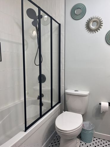Installed this cool tub/shower combo and a unique folding glass wall instead of using a shower curta
