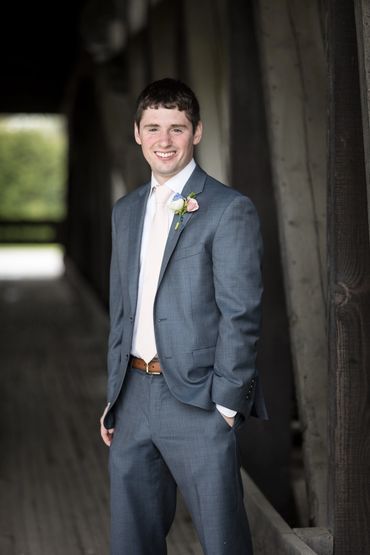 Groom boutonniere with white and blush flowers. 