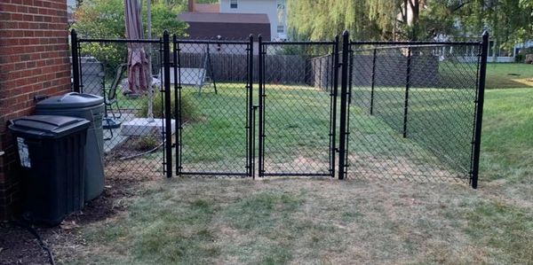 Chain link fence with gate for access to the back yard