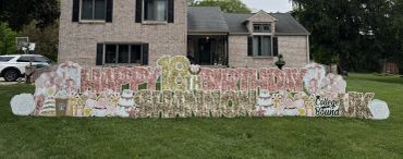 Happy Birthday yard sign in front of a house.