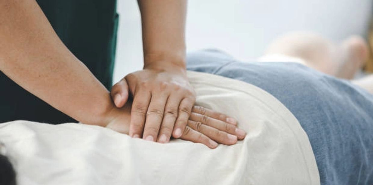 Chiropractor adjusting low back pain
