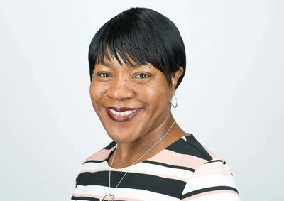 black woman with short hair smiling