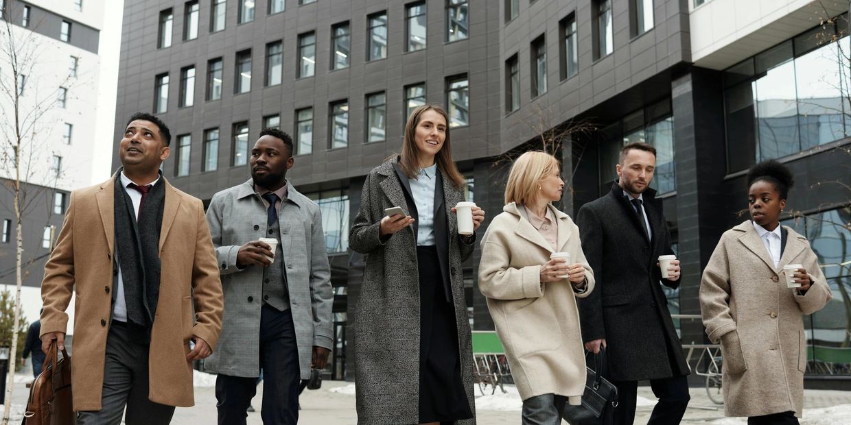 A group of people men and women walking outside 