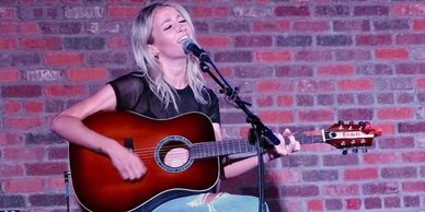 Kalsey Kulyk singing and playing her Cithara Guitars acoustic dreadnought.