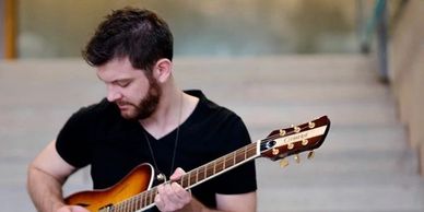 Ontario musician Patrick James Clark with his standard hollow-body model guitar.