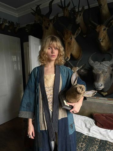 Model wearing antique Japanese indigo kimono and holding taxidermy anteater head