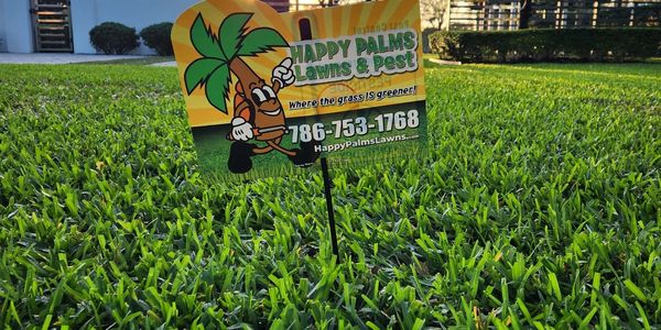 Green grass with lawn sign