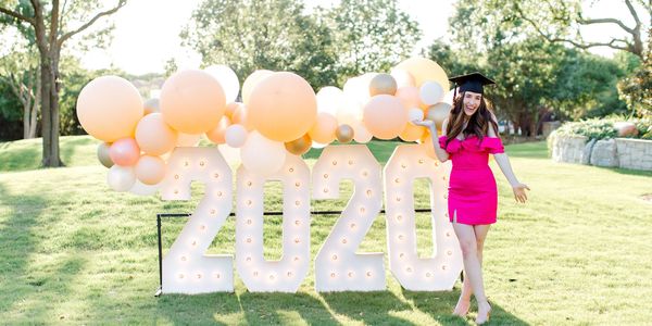 Graduation display with girl smiling and balloons