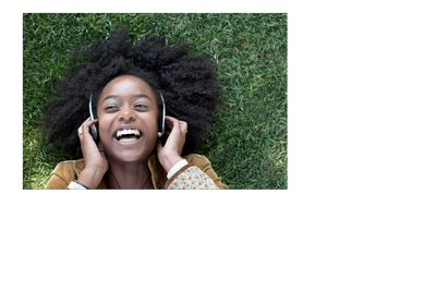 Photo of woman smiling while laying on the grass.